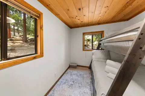 Bunk room with a gray bunk bed and pine ceiling, Homewood Cabin in the Pines