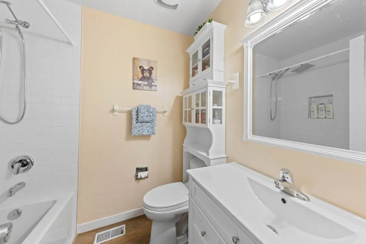 Bathroom with a tub shower and white vanity, Cortina Chalet