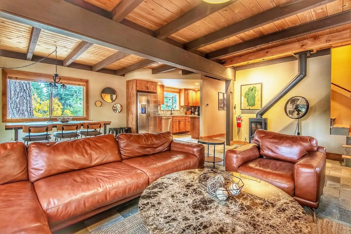 Living room with leather sofas and kitchen beyond, Restful North Ridge