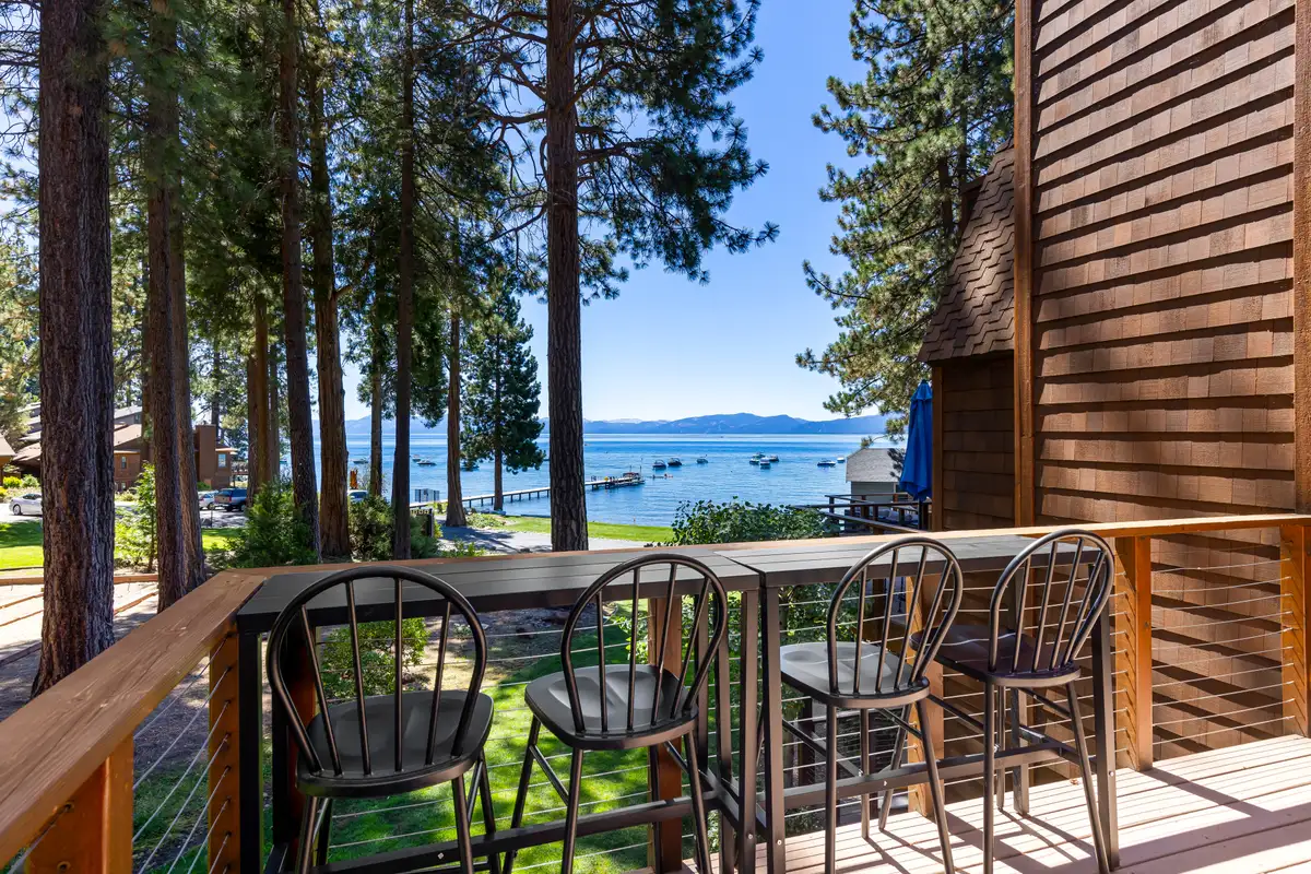 Deck with bar stools and Lake Tahoe beyond the trees, Lakeside Luxe Retreat