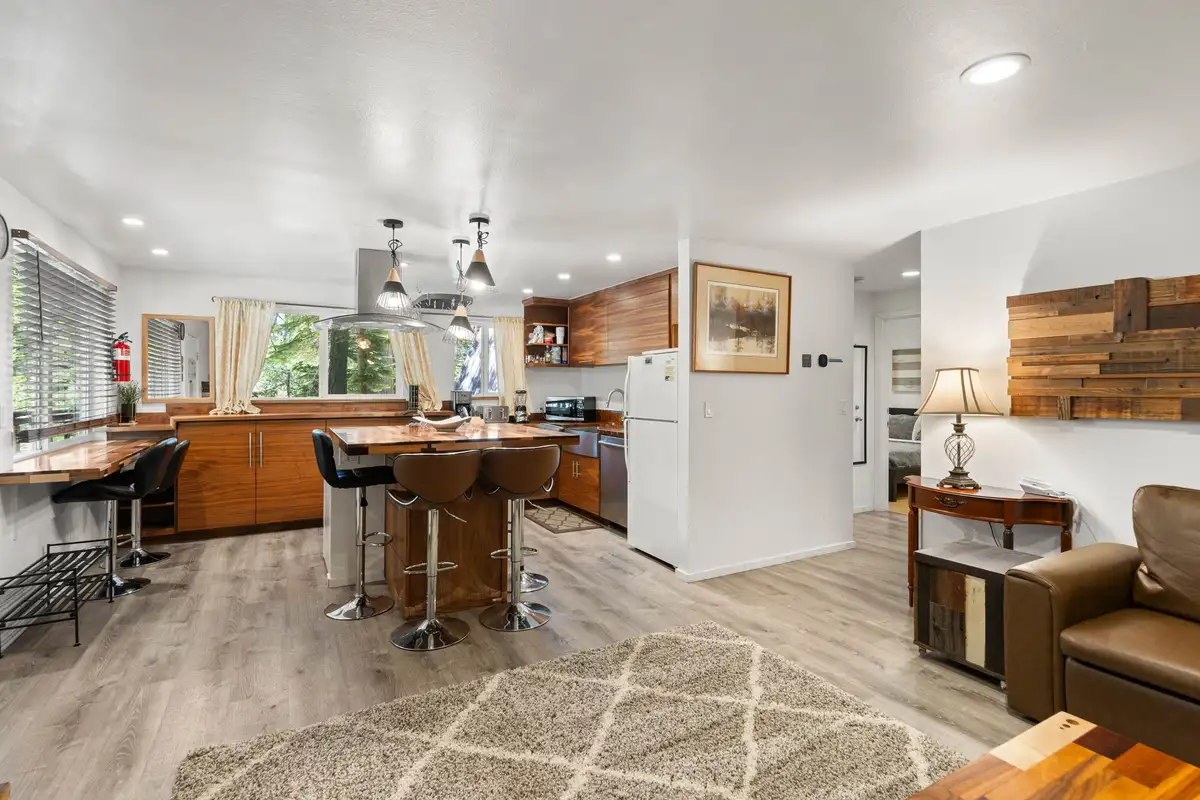 Open kitchen with breakfast bar stools and a leather sofa, Tahoe Lake & Mountain Retreat
