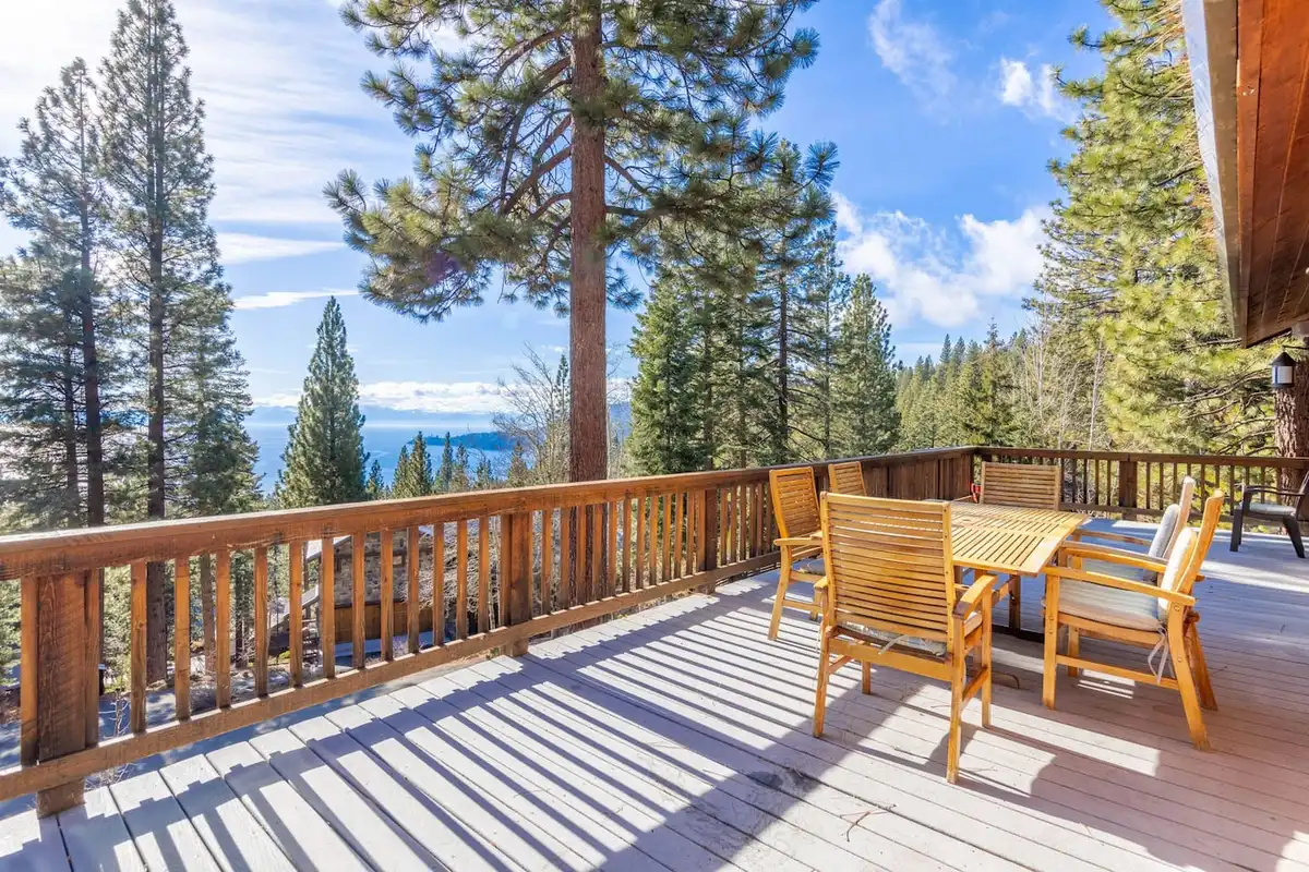 Sunny deck with wood patio chairs and table among pines, Tranquil Alpine Bliss