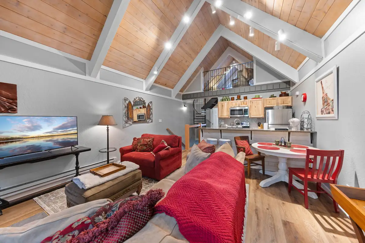 Open living room with vaulted ceiling and red sofa, Tahoe Peaks & Shores Retreat