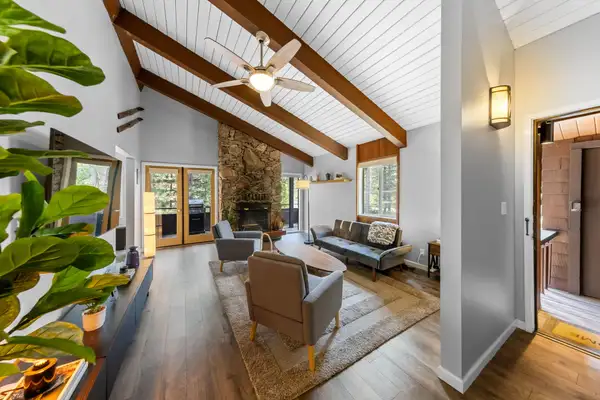 Living room with beamed ceiling and stone fireplace, Incline Tranquil Loft