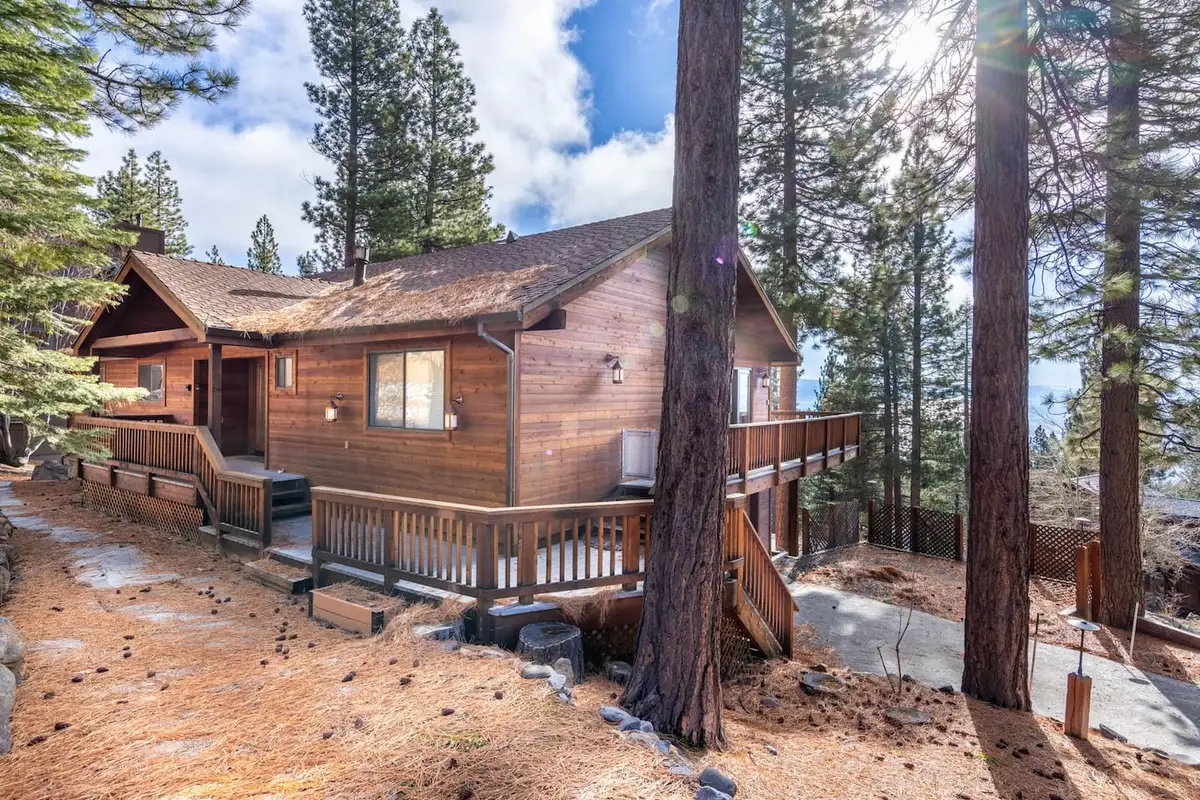 Wood-sided home with a deck among tall pines, Tranquil Alpine Bliss