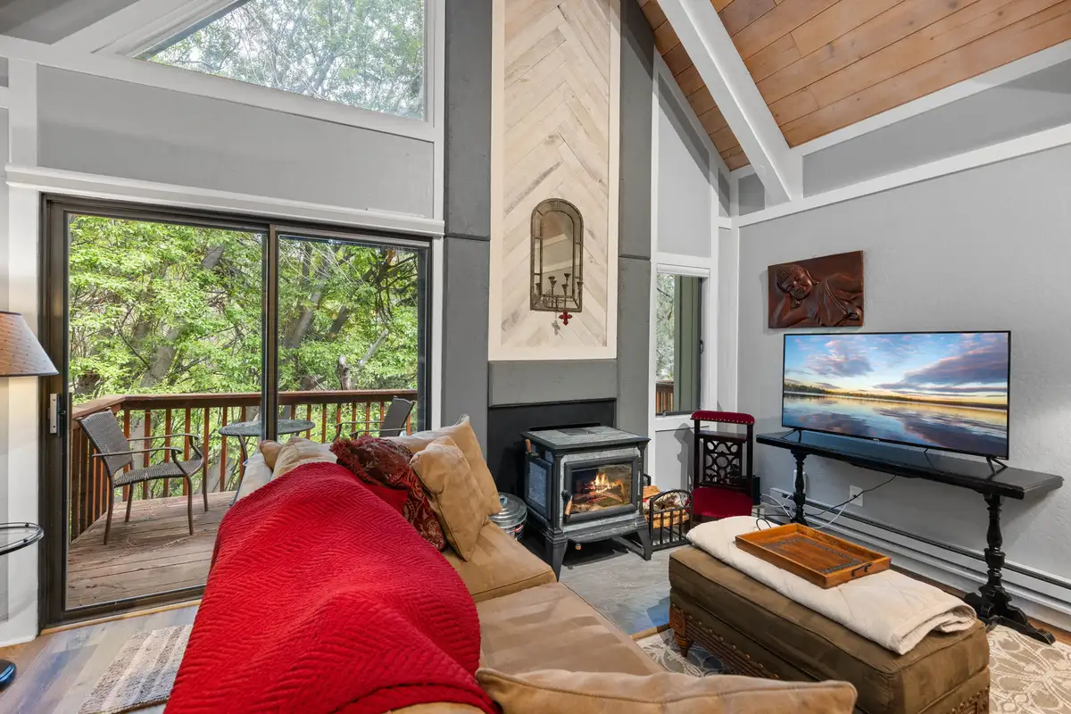 Living room with wood stove and sliding door to deck, Tahoe Peaks & Shores Retreat