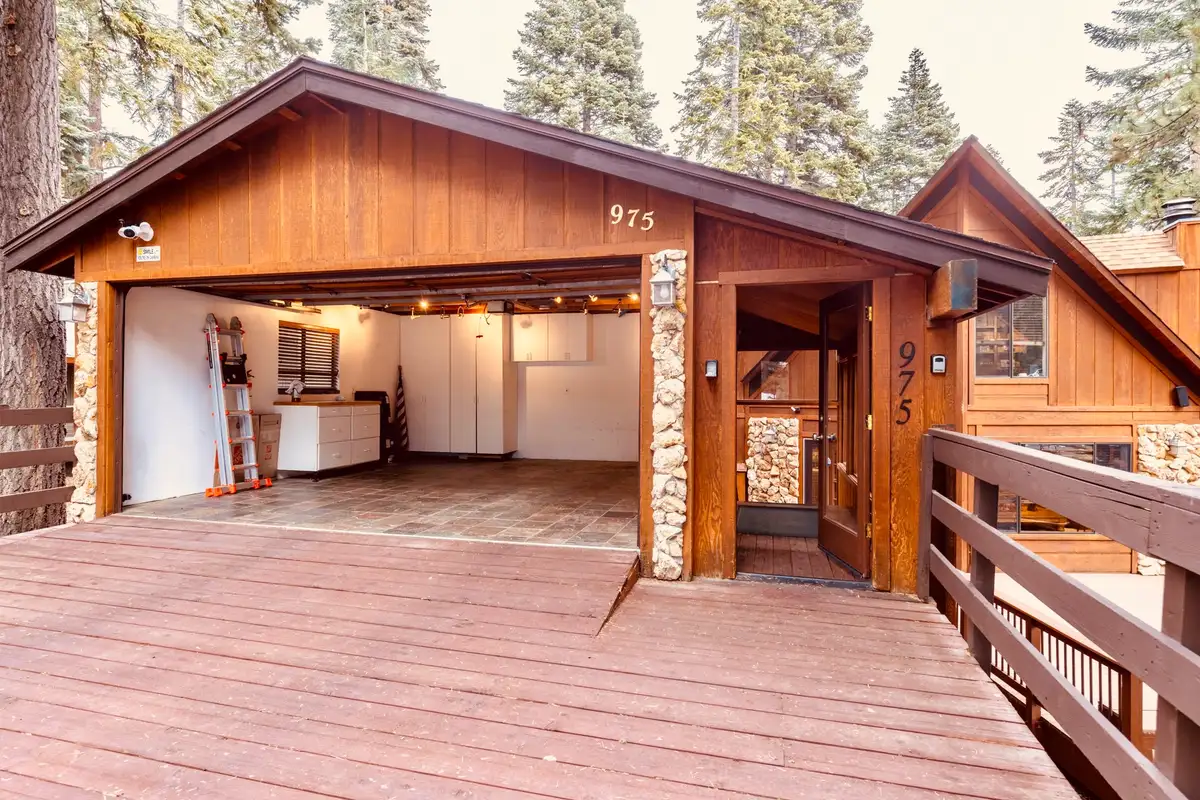 Open garage and wood deck at the front of a cabin, Sunlit Incline Retreat