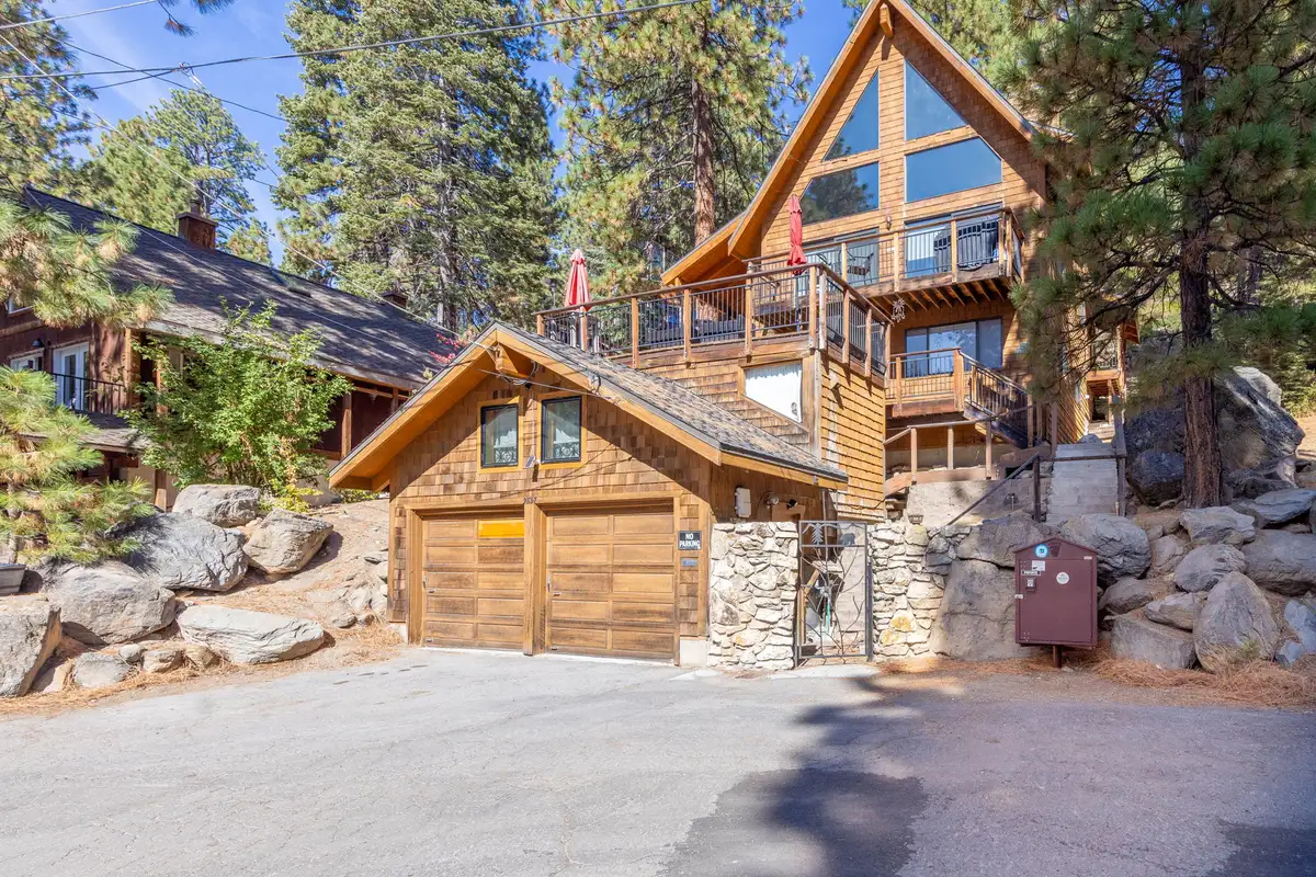 A-frame home with two-car garage and boulder landscaping, Rustic Ridge Retreat
