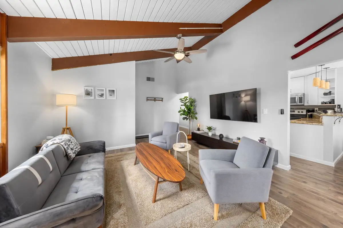 Living room with gray sofa and kitchen beyond, Incline Tranquil Loft