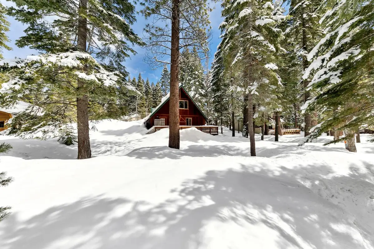 A-frame cabin in a snowy pine forest, Patton's Pfeiffer Cabin