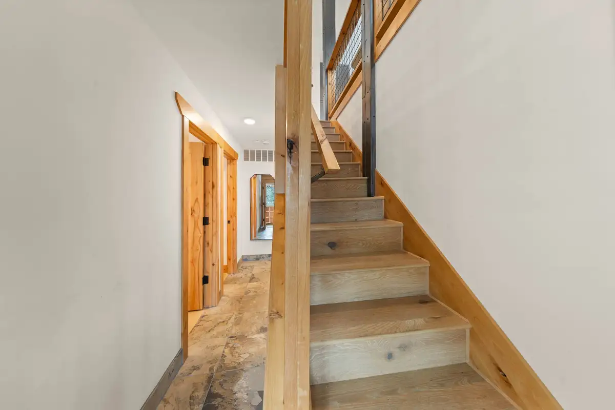 Hallway with wooden stairs and plank floors, Sugar Pine Tahoe Lodge