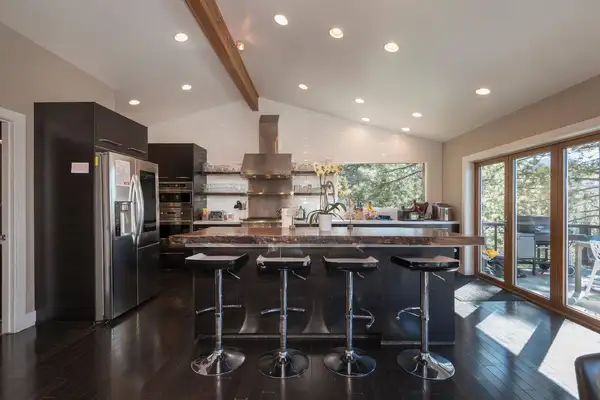 Kitchen with dark cabinets, island bar stools and vaulted ceiling, Skylake Serenity Retreat