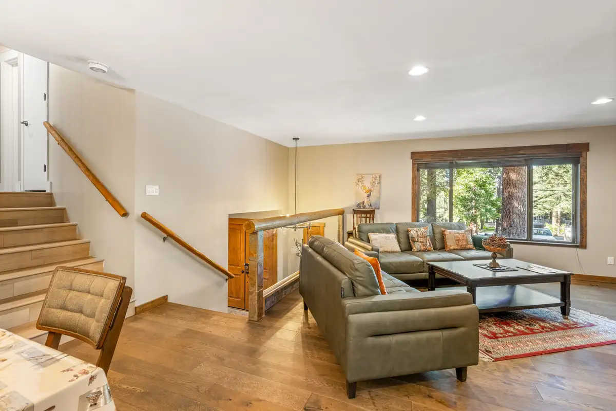 Living room with a sectional sofa and staircase railing, Tranquil Stay