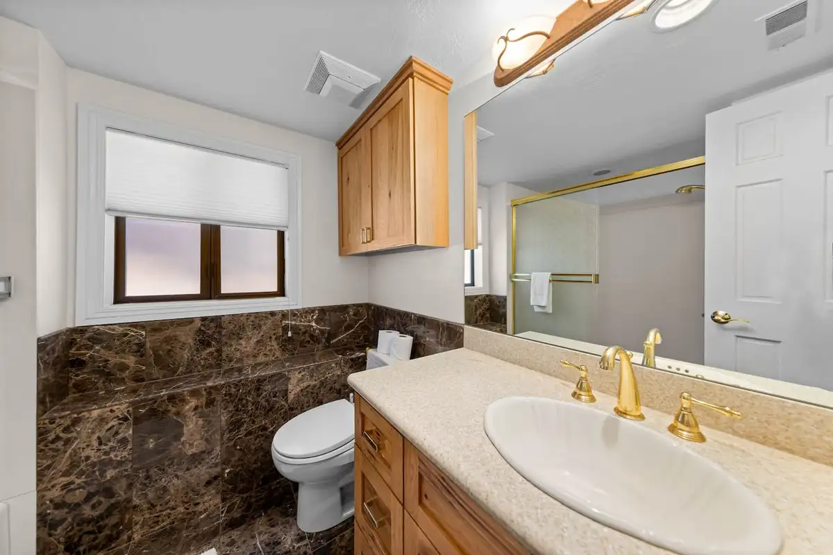 Bathroom with marble wall tile and a wood vanity, Tranquil Alpine Bliss
