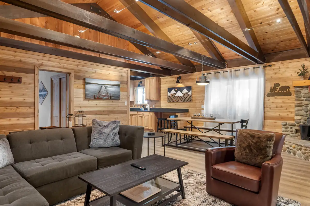 Living room with sectional sofa and dining area beyond, Updated West Shore Cabin 1 mile to Chambers Beach