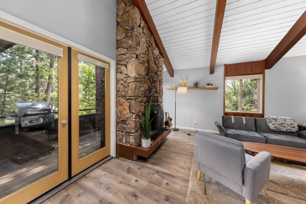 Living room with stone fireplace and glass doors to a deck, Incline Tranquil Loft