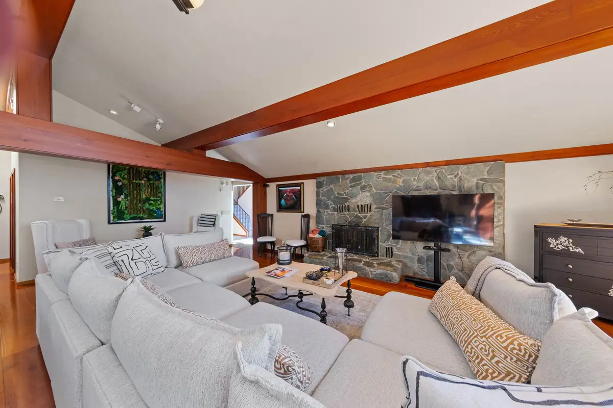 Living room with white sectional and stone fireplace, Incline Lakeside Haven