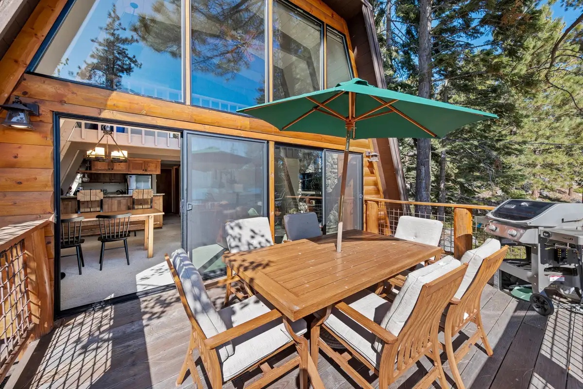 Deck with umbrella dining table beside A-frame windows, Livin' on the Edge