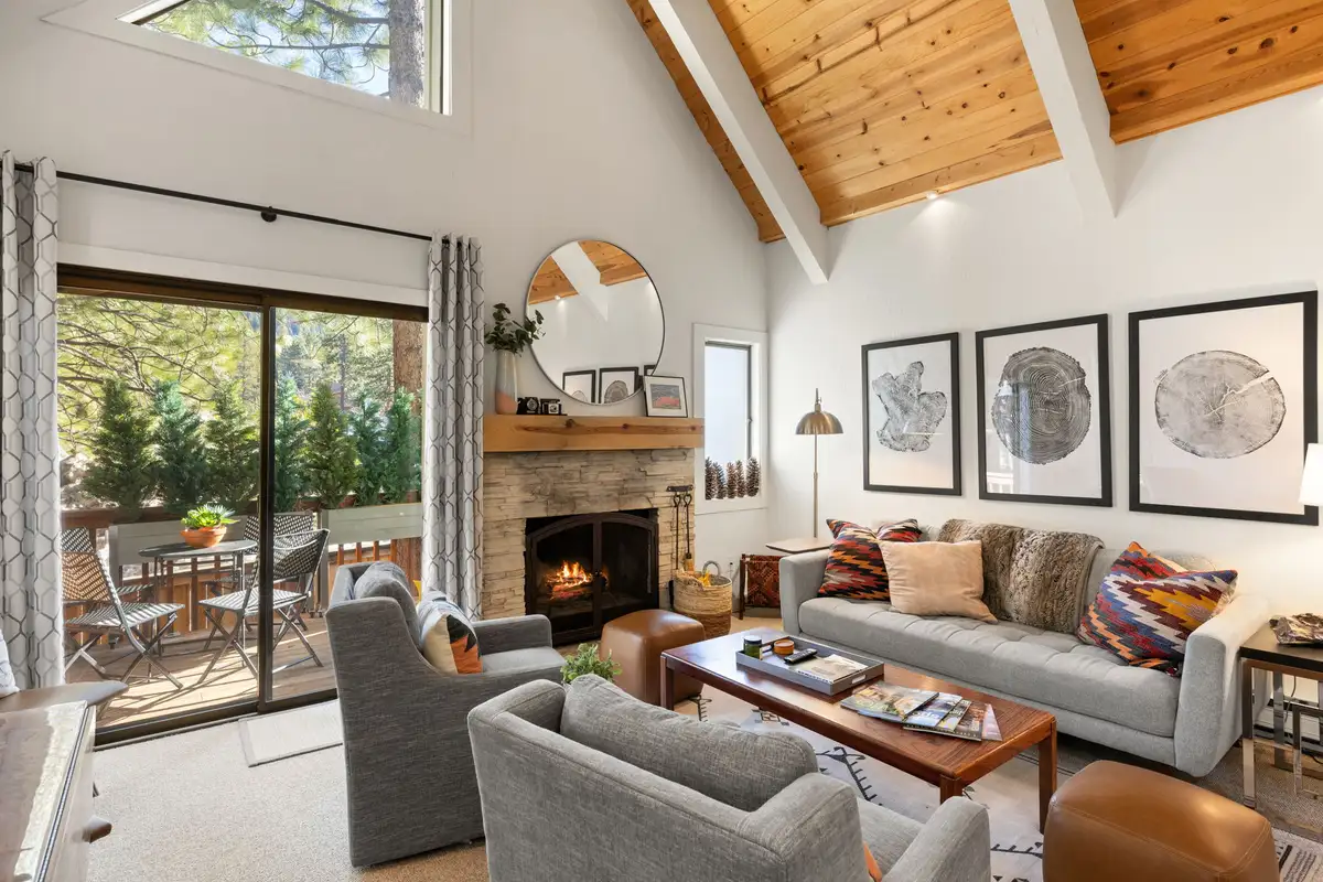 Living room with stone fireplace and vaulted wood ceiling, Serenity Bungalow