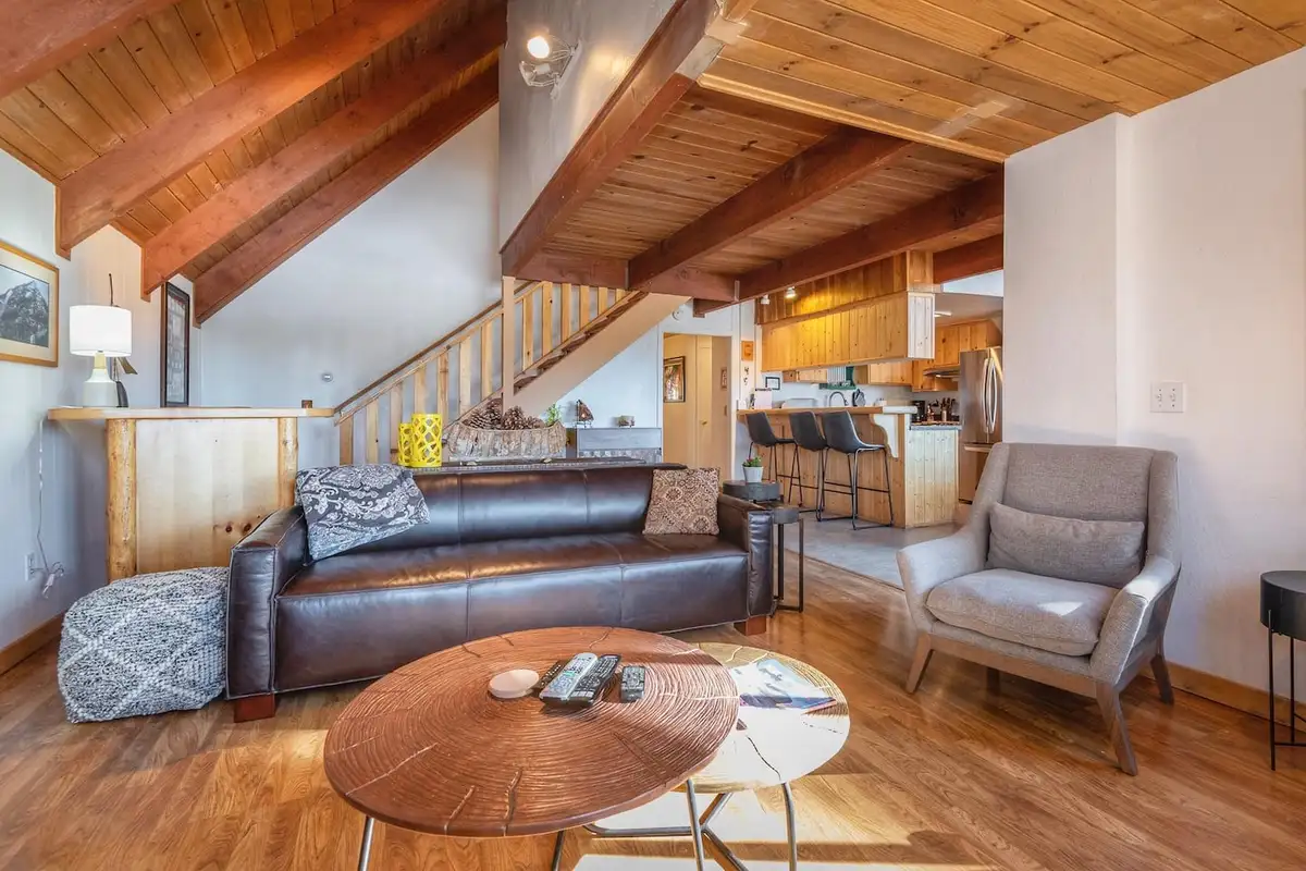 Living room with leather sofa and stairs to a loft, Lakeview Serenity Cottage