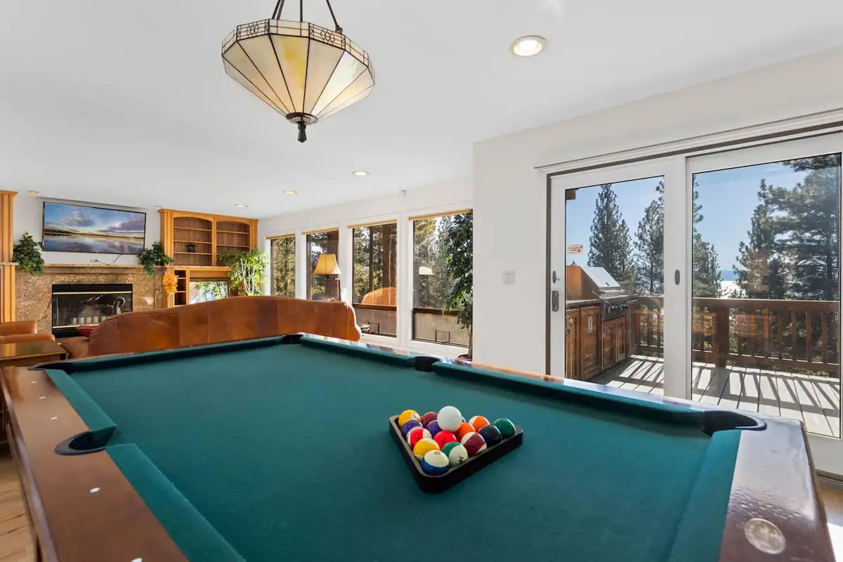 Pool table in a sunny room with fireplace and deck doors, Tranquil Alpine Bliss
