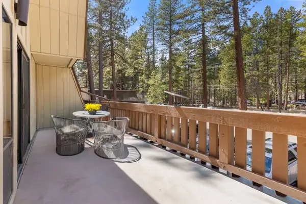 Private balcony with bistro seating surrounded by towering pines, Treetop on Country Club