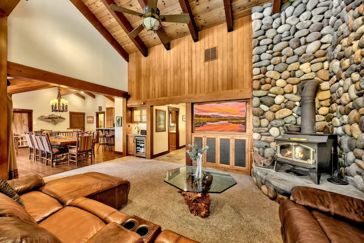 Great room with river rock wall and wood stove, Mammoth Haven Retreat