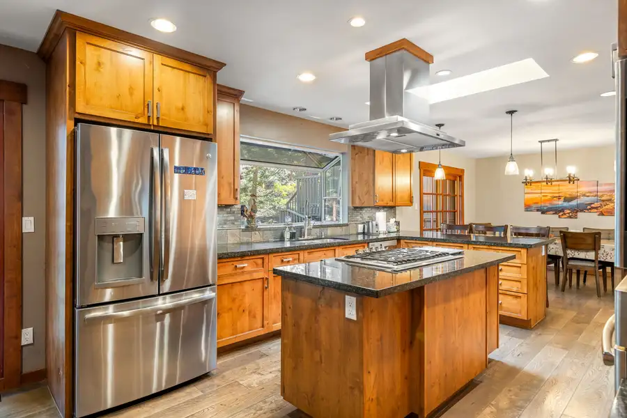 Kitchen with an island cooktop and stainless refrigerator, Tranquil Stay