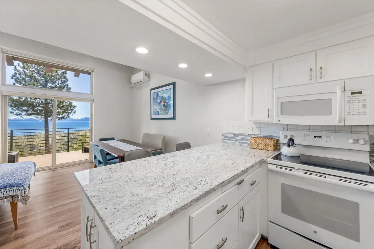 Kitchen with granite counters and Lake Tahoe visible through the windows, Lakeview Haven in Incline Village