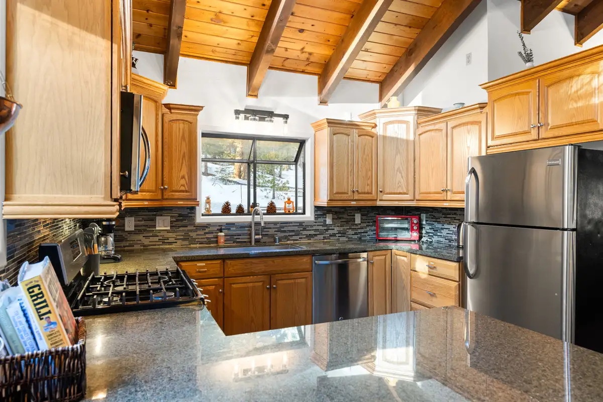 Kitchen with wood cabinets and stainless refrigerator, Sierra Woodlands Getaway