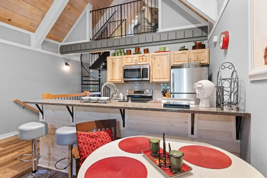 Kitchen breakfast bar with spiral stairs to the loft, Tahoe Peaks & Shores Retreat