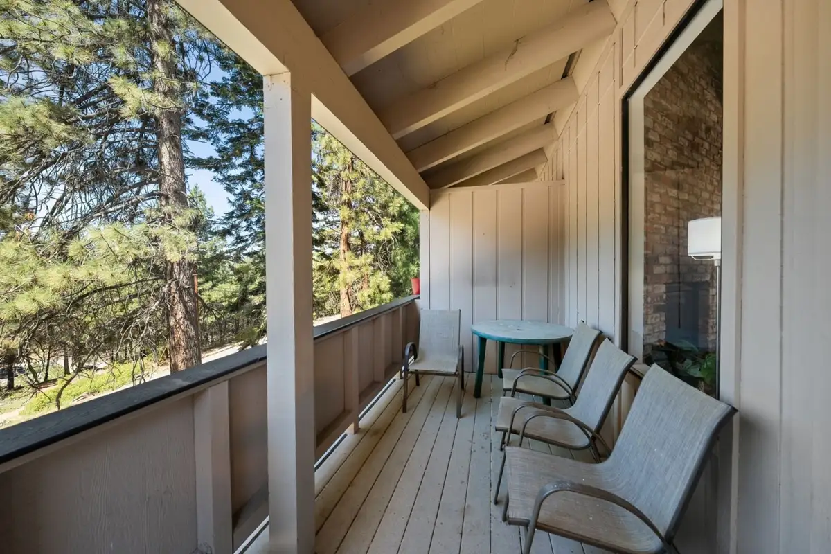 Covered balcony with patio chairs and table, Skiway Suite
