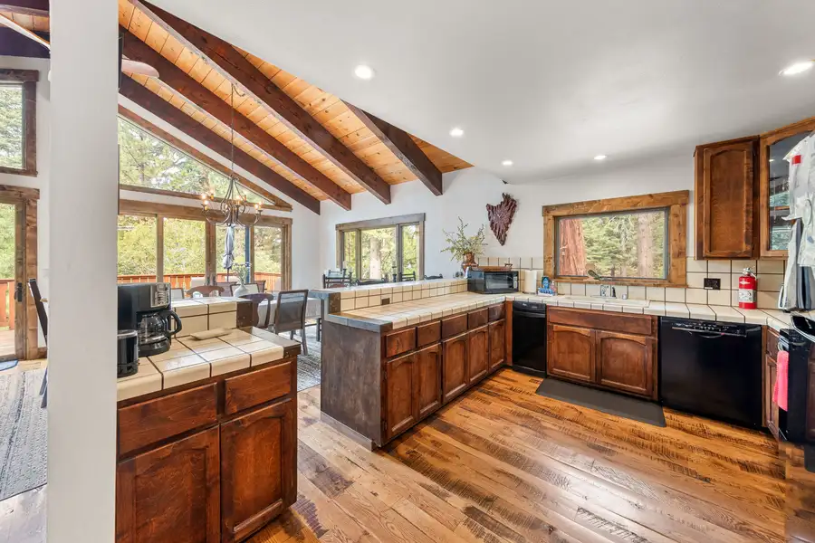 Kitchen with wood cabinets and tile counters, Evergreen Hideout