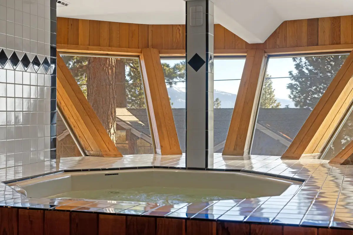 Indoor hot tub surrounded by angled windows, 90s Tahoe Time Capsule