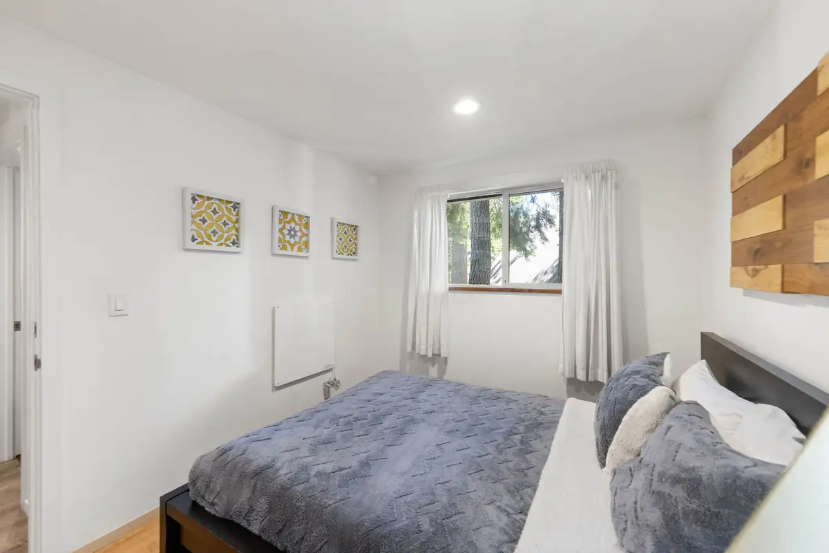 Bedroom with a bed and a window with white curtains, Tahoe Lake & Mountain Retreat