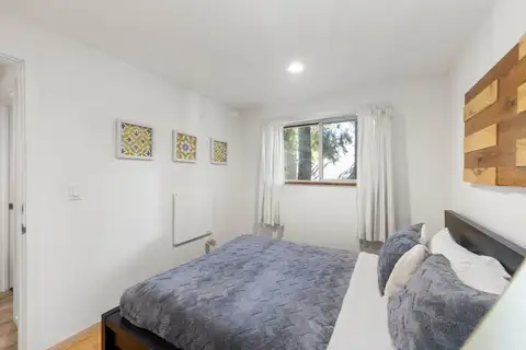 Bedroom with a bed and a window with white curtains, Tahoe Lake & Mountain Retreat