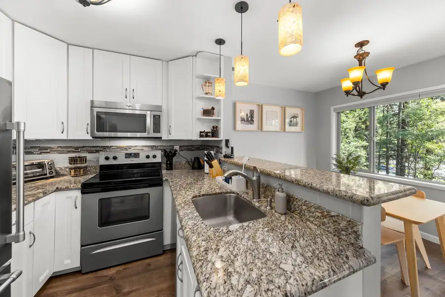Kitchen with white cabinets and granite counters, Incline Tranquil Loft