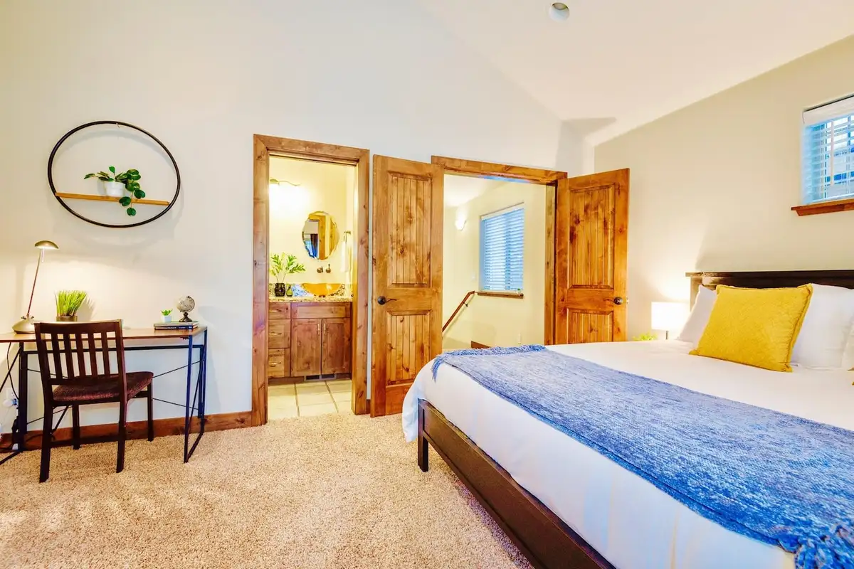 Bedroom with a desk and doorway to an ensuite bathroom, Trout and About