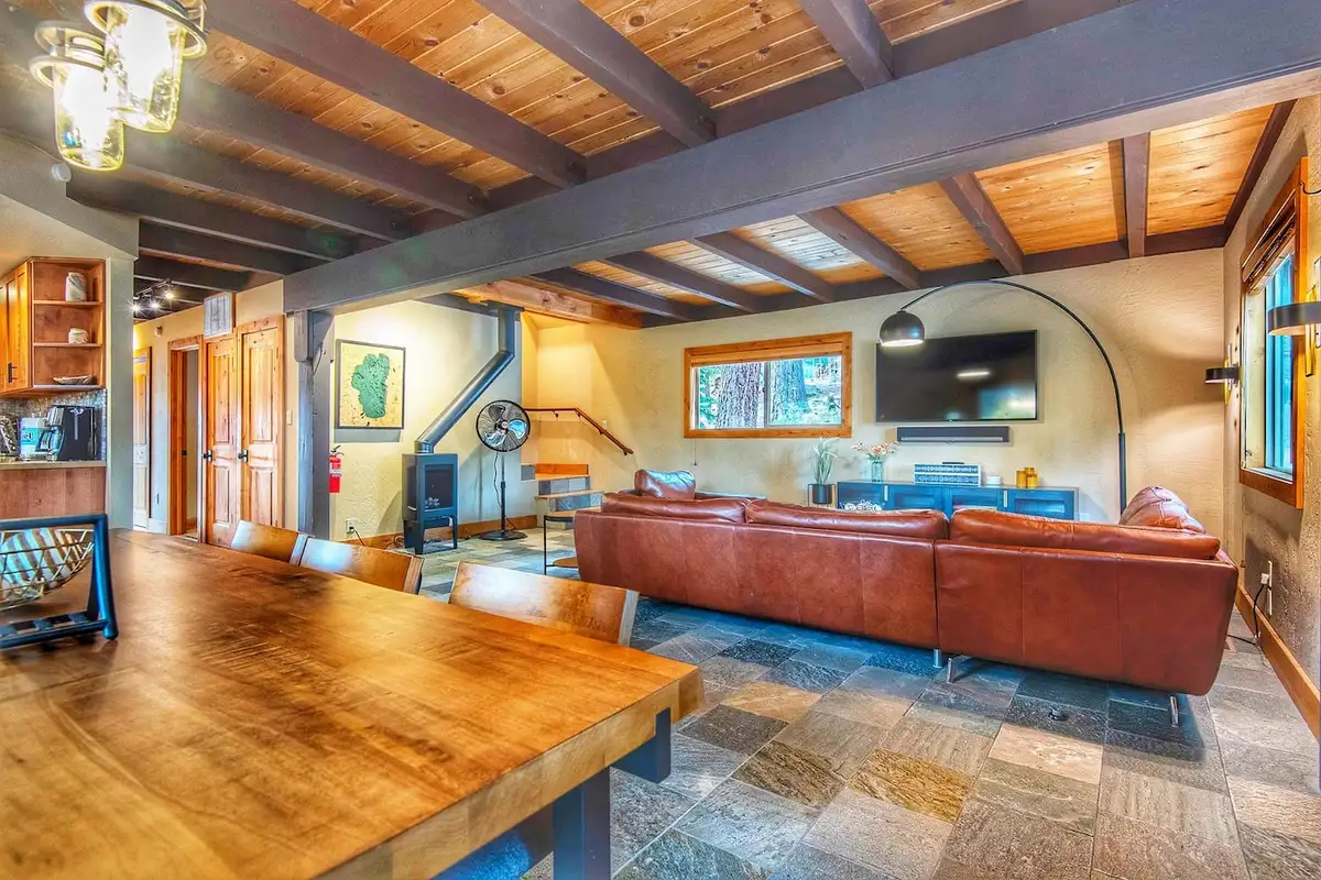 Open living room with leather sectional and exposed wood ceiling beams, Restful North Ridge