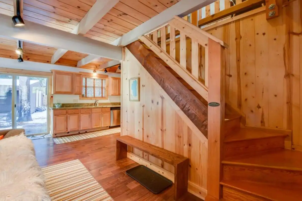 Pine staircase with a bench beside the kitchen, Tranquil Trails Cabin