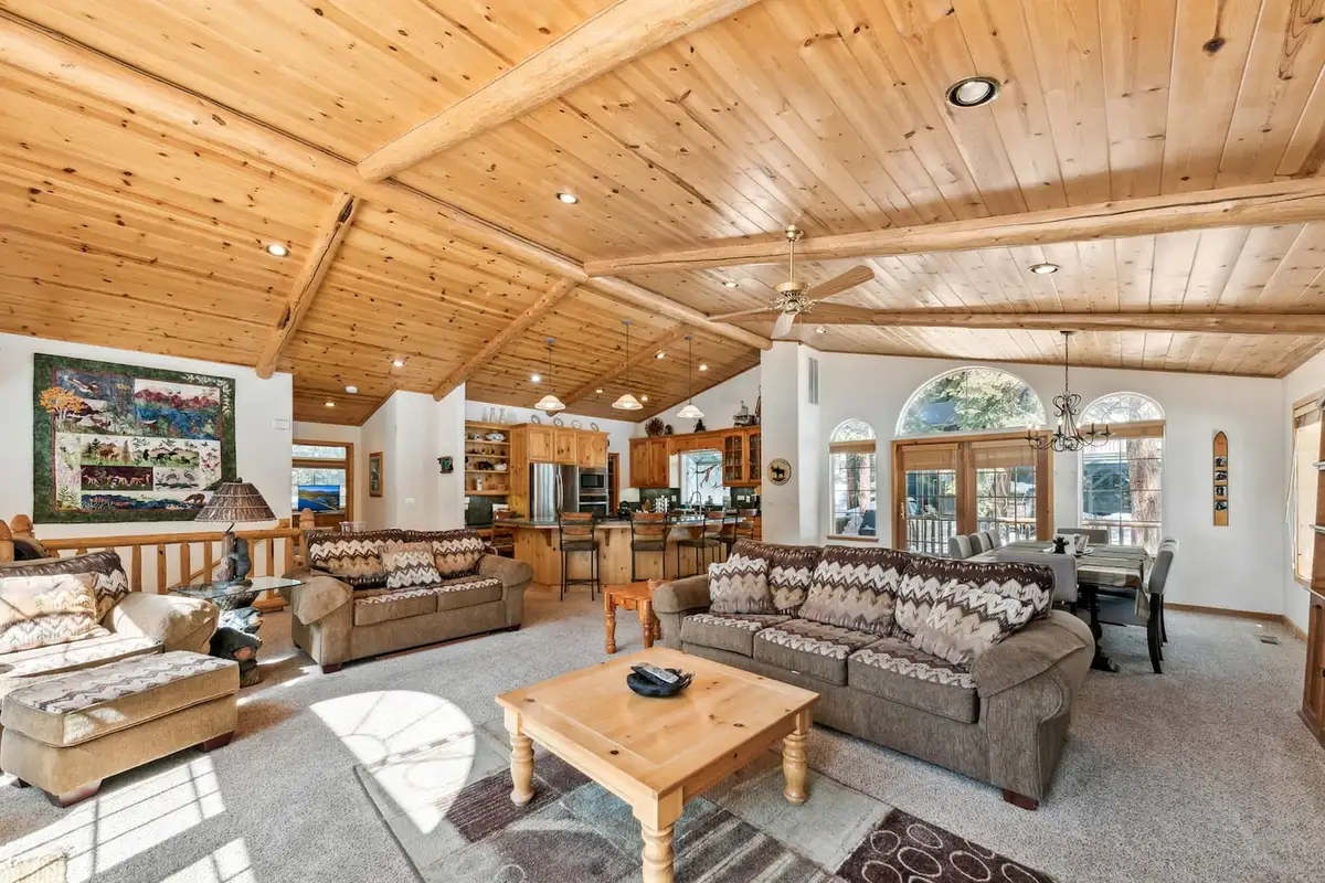 Open living area with wood ceiling and leather sofas, Hastings Hideaway Cabin