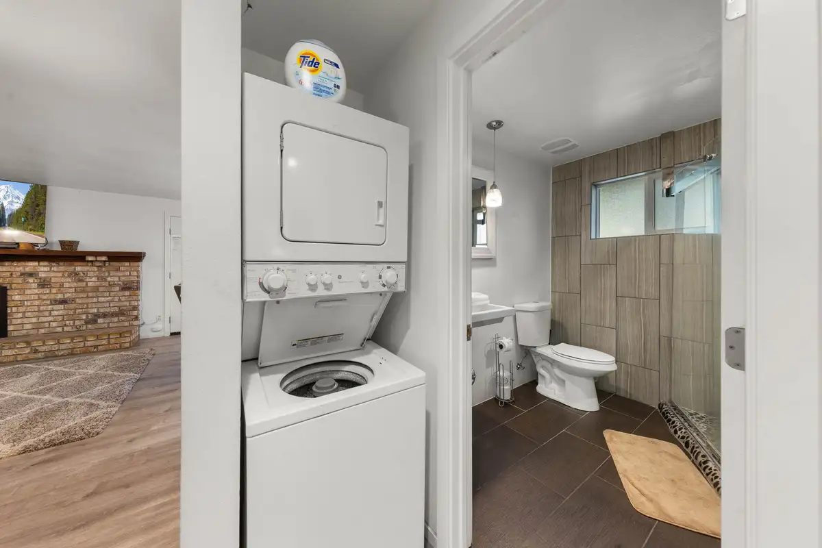Stacked washer and dryer beside a bathroom, Tahoe Lake & Mountain Retreat