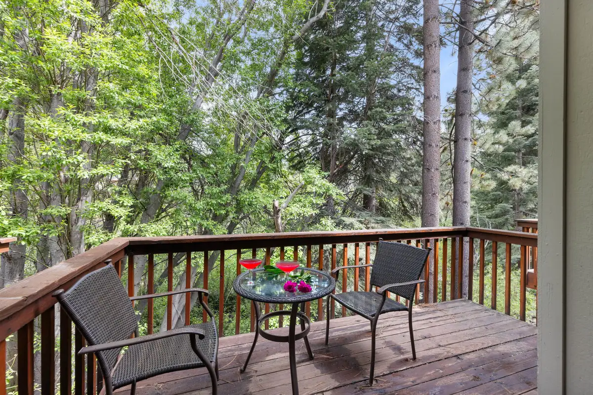 Deck with bistro table and chairs among trees, Tahoe Peaks & Shores Retreat