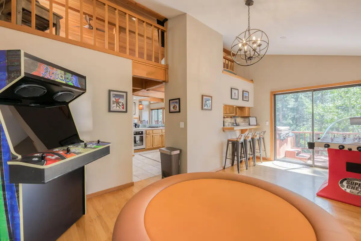 Game area with an arcade cabinet and a poker table, Lunar Lakeview Haven
