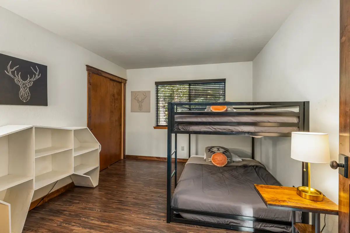 Bedroom with a metal bunk bed and shelves, Grand Regency Retreat