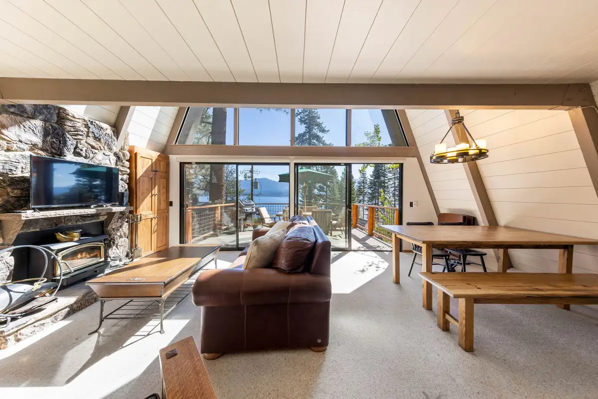 A-frame living room with stone fireplace and dining table, Livin' on the Edge