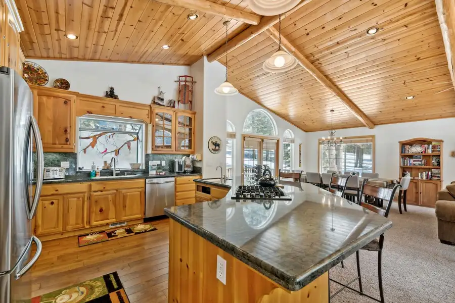 Kitchen with a dark granite island and gas cooktop, Hastings Hideaway Cabin