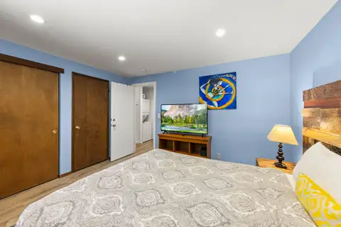 Blue-walled bedroom with a bed and TV on a stand, Tahoe Lake & Mountain Retreat