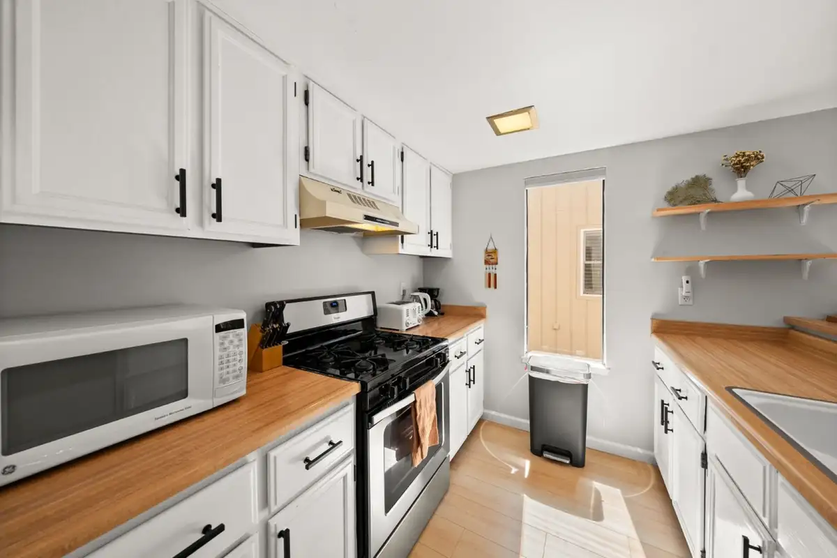 Kitchen with white cabinets and gas range, Skiway Suite