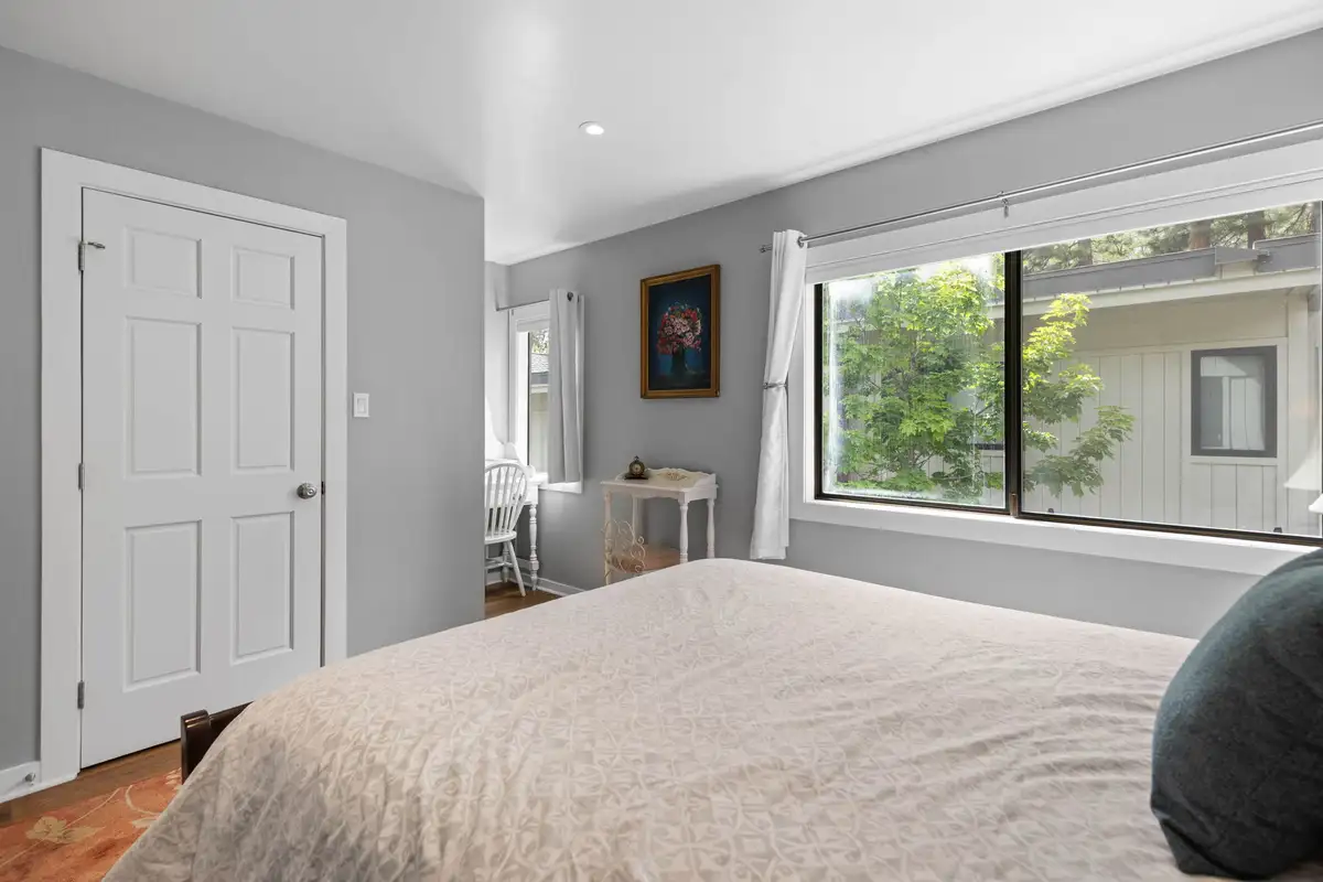 Bedroom with a bed and large window, Tahoe Peaks & Shores Retreat